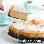 cake server lifting a slice of cheesecake off of a serving plate