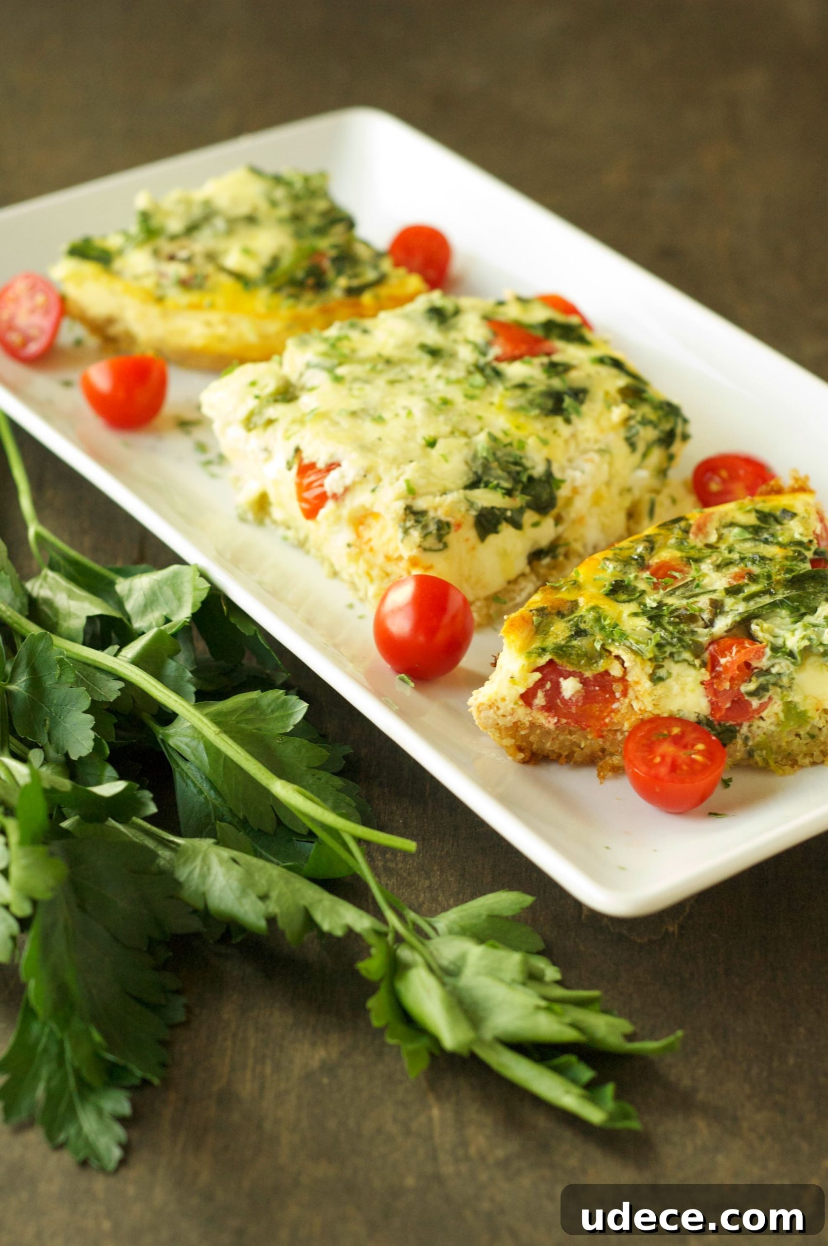 side view of 3 pieces of breakfast casserole on white oblong plate