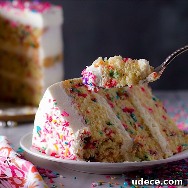 All-Butter Funfetti Cake & Cupcakes Recipe 9 Taking a bite of Funfetti Cake with Classic American Buttercream.