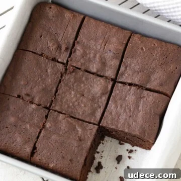 Gluten-free brownies with melted chocolate in a square pan after baking.