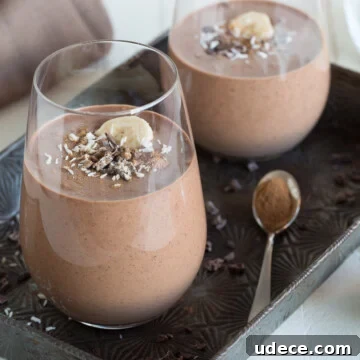 two chocolate smoothies in glasses on an antique tray.