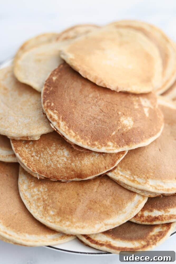 High-Protein Cottage Cheese Pancakes Recipe 3 a plate full of cottage cheese protein pancakes.
