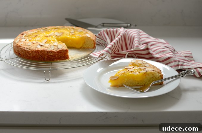 Lemon Custard Almond Cake is sliced and ready to serve