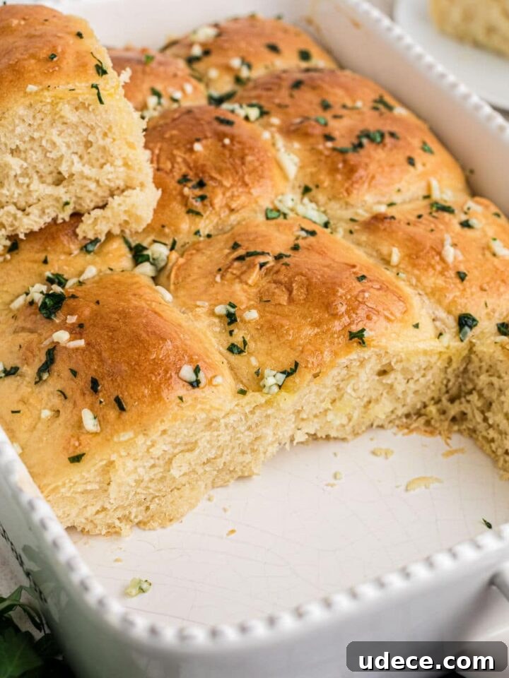 A baking dish with garlic butter rolls just cooked.