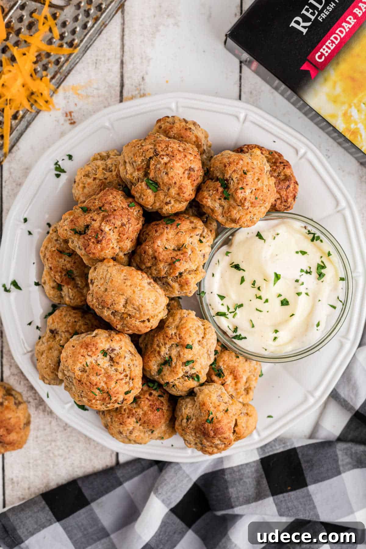 Cheddar Bay-Style Sausage Balls Recipe for Parties and Snacks 13 Overhead shot of a plate full of cheddar bay sausage balls with a ranch dip.