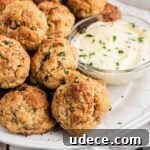 Cheddar Bay-Style Sausage Balls Recipe for Parties and Snacks 14 Close up of some cheddar bay sausage balls with ranch in a bowl.