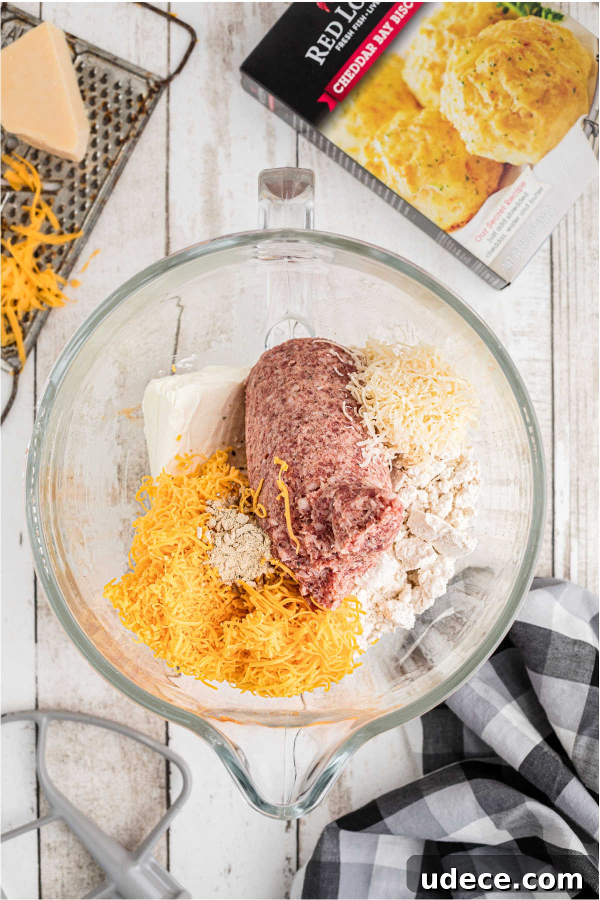Cheddar Bay-Style Sausage Balls Recipe for Parties and Snacks 4 A mixing bowl filled with biscuit mix and sausage meat and cheese.