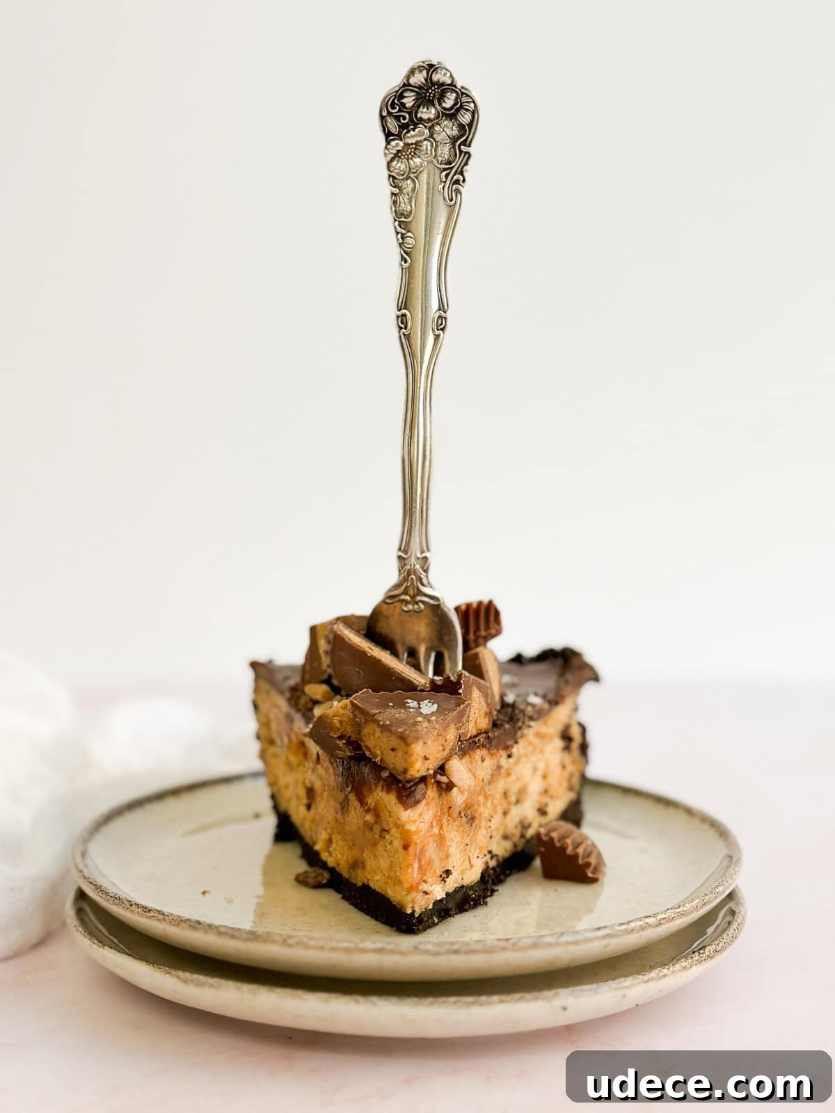 Decadent Peanut Butter Pie with Chocolate Ganache Recipe 13 a fork sticking out of the top of a slice of pie.