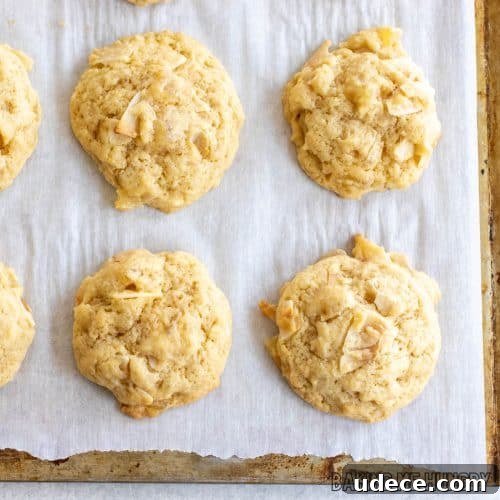 pineapple coconut cookies on parchment paper on baking sheet close up