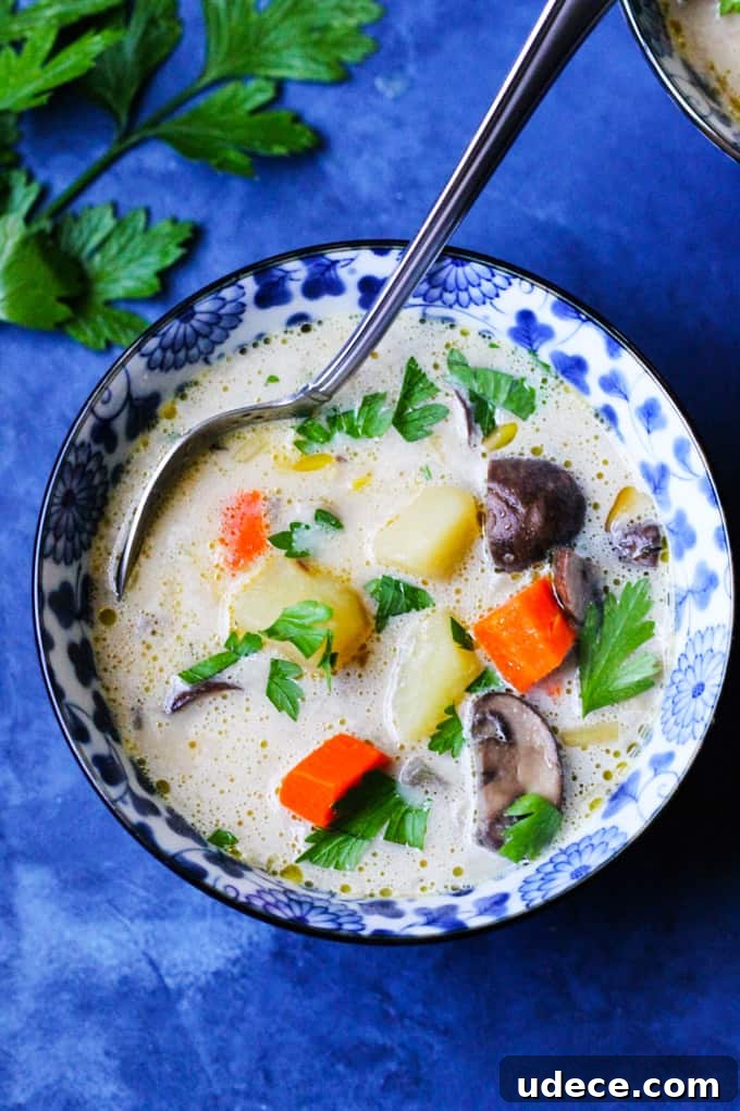 Polish Mushroom soup in a blue bowl with spoon