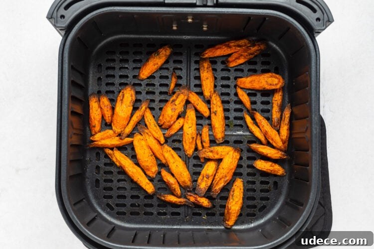Air fryer carrots in an air fryer basket.