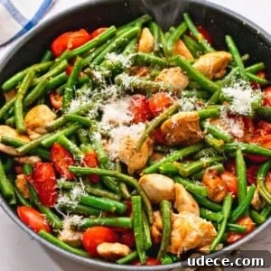 Garlic Butter Chicken with Sautéed Green Beans and Lemon 3 Skillet with chicken, tomatoes, green beans, and tomatoes.
