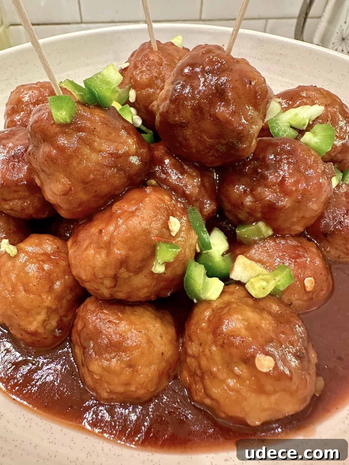 Sweet and Spicy Cranberry Jalapeño Meatballs Recipe 2 Meatballs in a serving bowl.