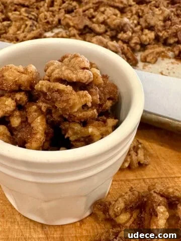Close-up of spiced walnuts roasted with cinnamon and sugar in a jar.