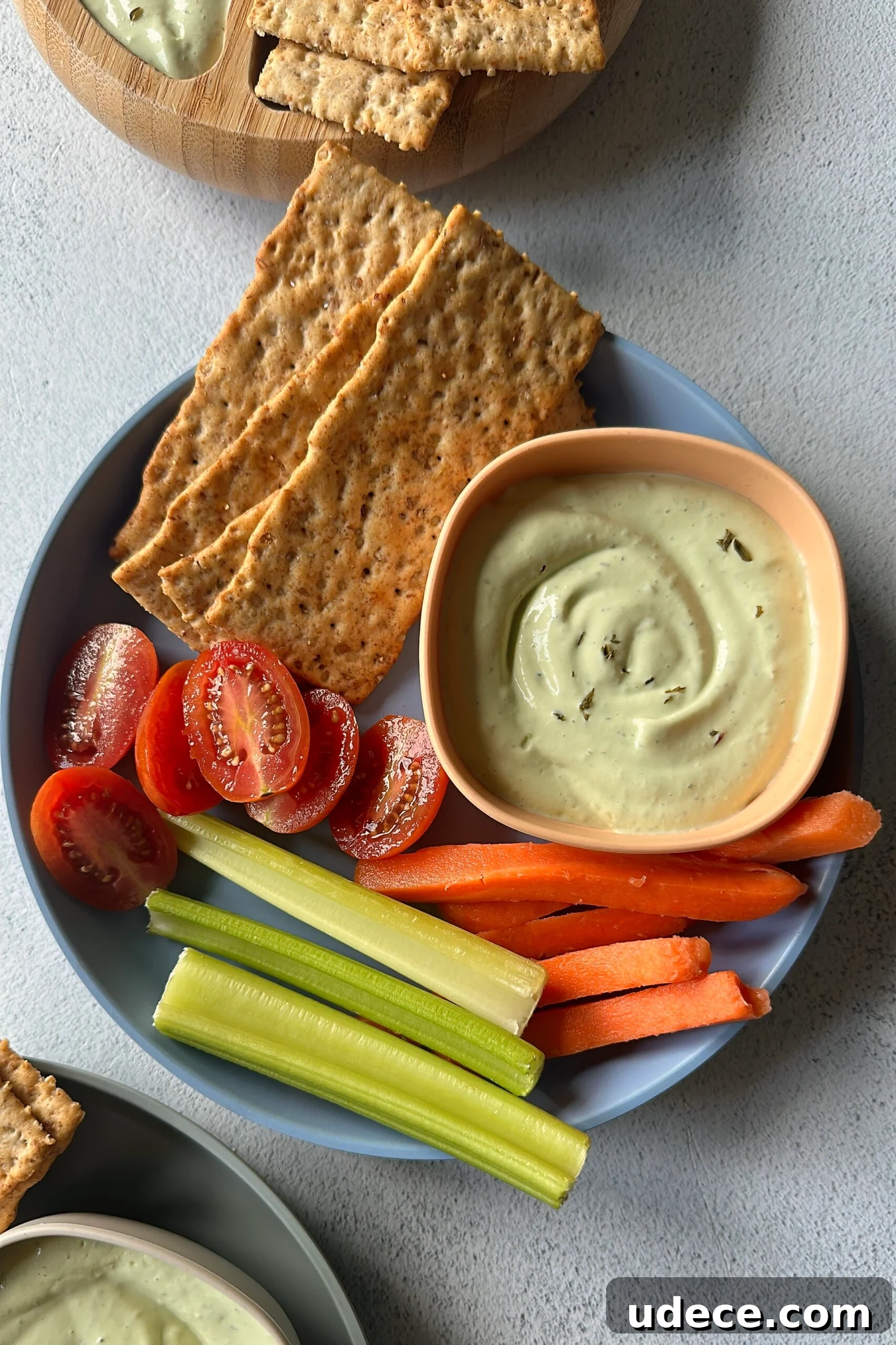 Creamy Avocado and Cottage Cheese Dip Recipe for Snacks 6 Avocado cottage cheese dip served with veggies and crackers.