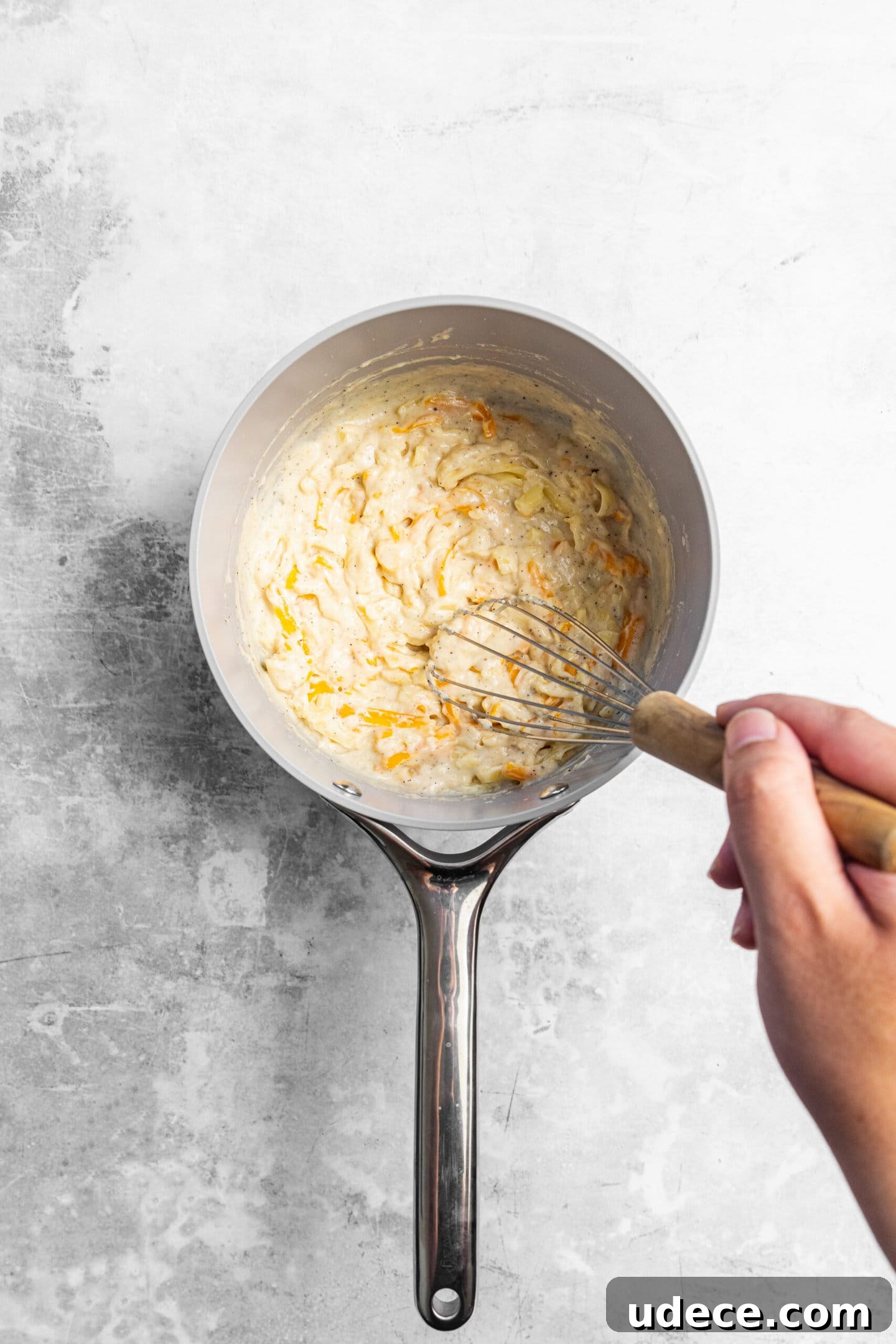Crispy Homemade Mac and Cheese Bites: Bite-Sized Comfort Food 6 Cheese being whisked into the roux.