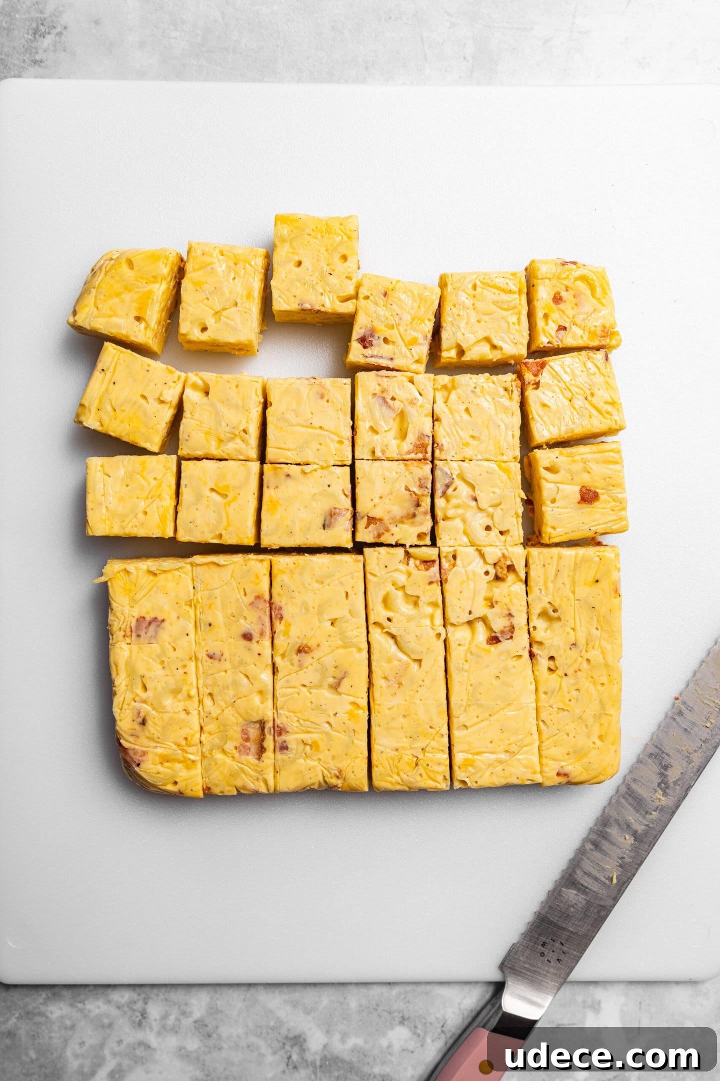 Crispy Homemade Mac and Cheese Bites: Bite-Sized Comfort Food 9 Bacon mac and cheese being sliced into bite sized pieces.