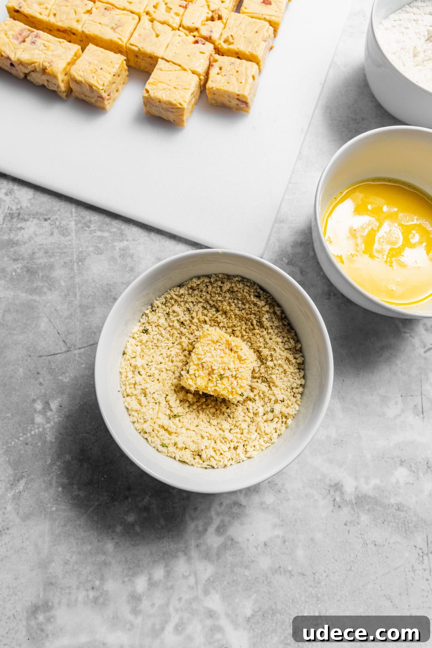 Crispy Homemade Mac and Cheese Bites: Bite-Sized Comfort Food 10 Mac and cheese bites being breaded.