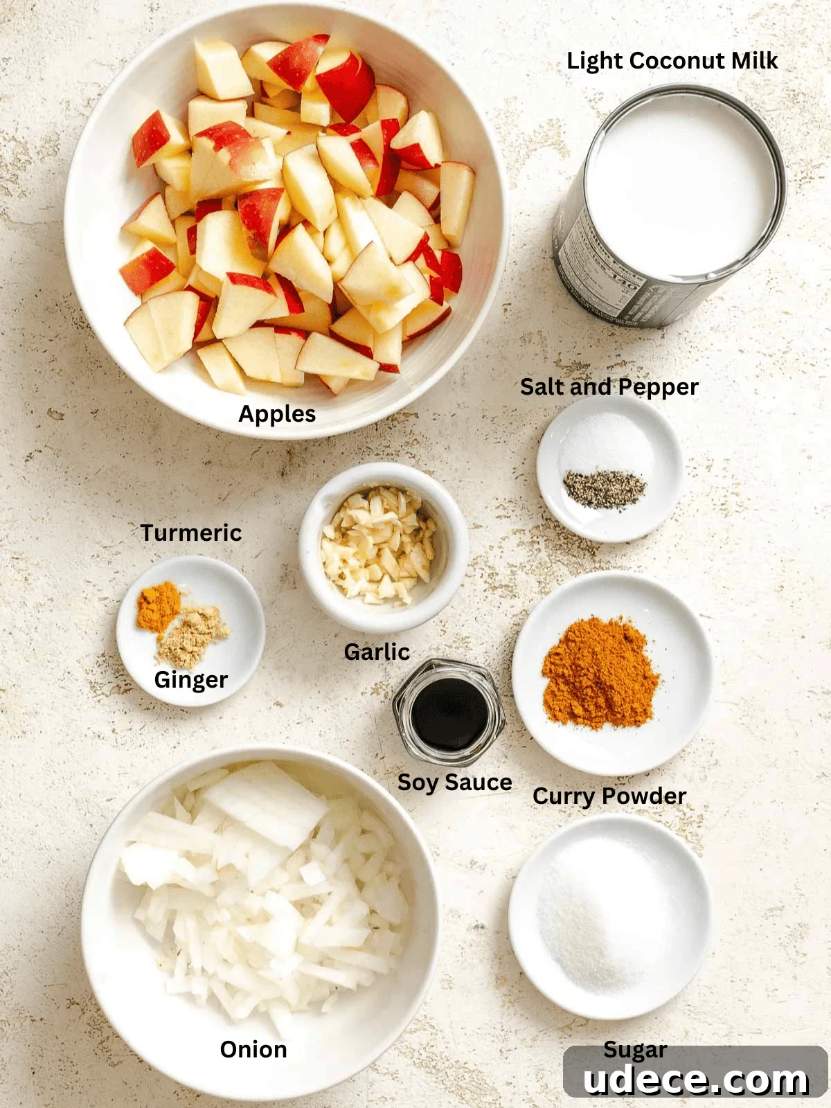 Creamy Apple Curry Recipe with Warm Spices and Coconut Milk 4 Ingredients for Creamy Apple Curry measured out on a white surface.