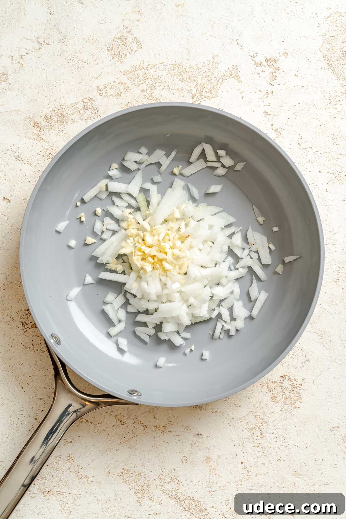 Creamy Apple Curry Recipe with Warm Spices and Coconut Milk 5 Process shot showing ingredients cooking on pan.