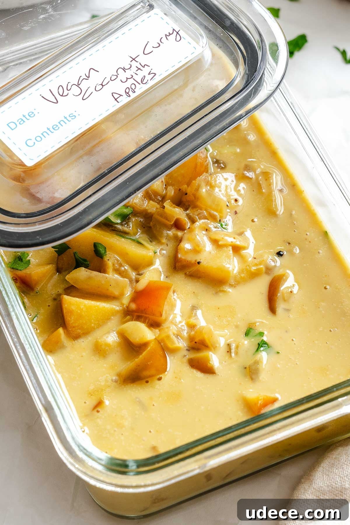 Creamy Apple Curry Recipe with Warm Spices and Coconut Milk 10 Completed Creamy Apple Curry in a storage container.
