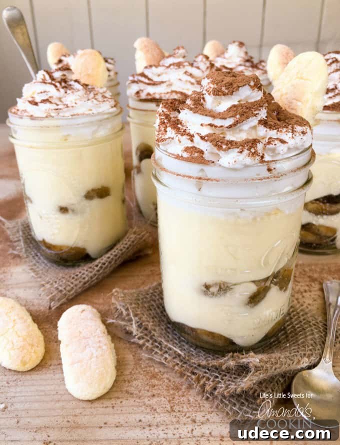 A close up photo of tiramisu trifles in mason jars.
