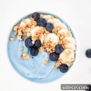 Vibrant Blue Spirulina Smoothie Bowl Recipe for Instagram-Worthy Breakfast 10 Blue smoothie bowl topped with sliced banana, blueberries, and granola.