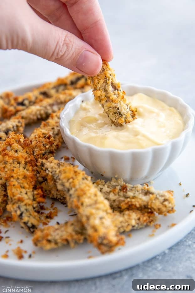 baked portobello mushrooms a healthy baked portobello mushroom fry being dipped into homemade aioli