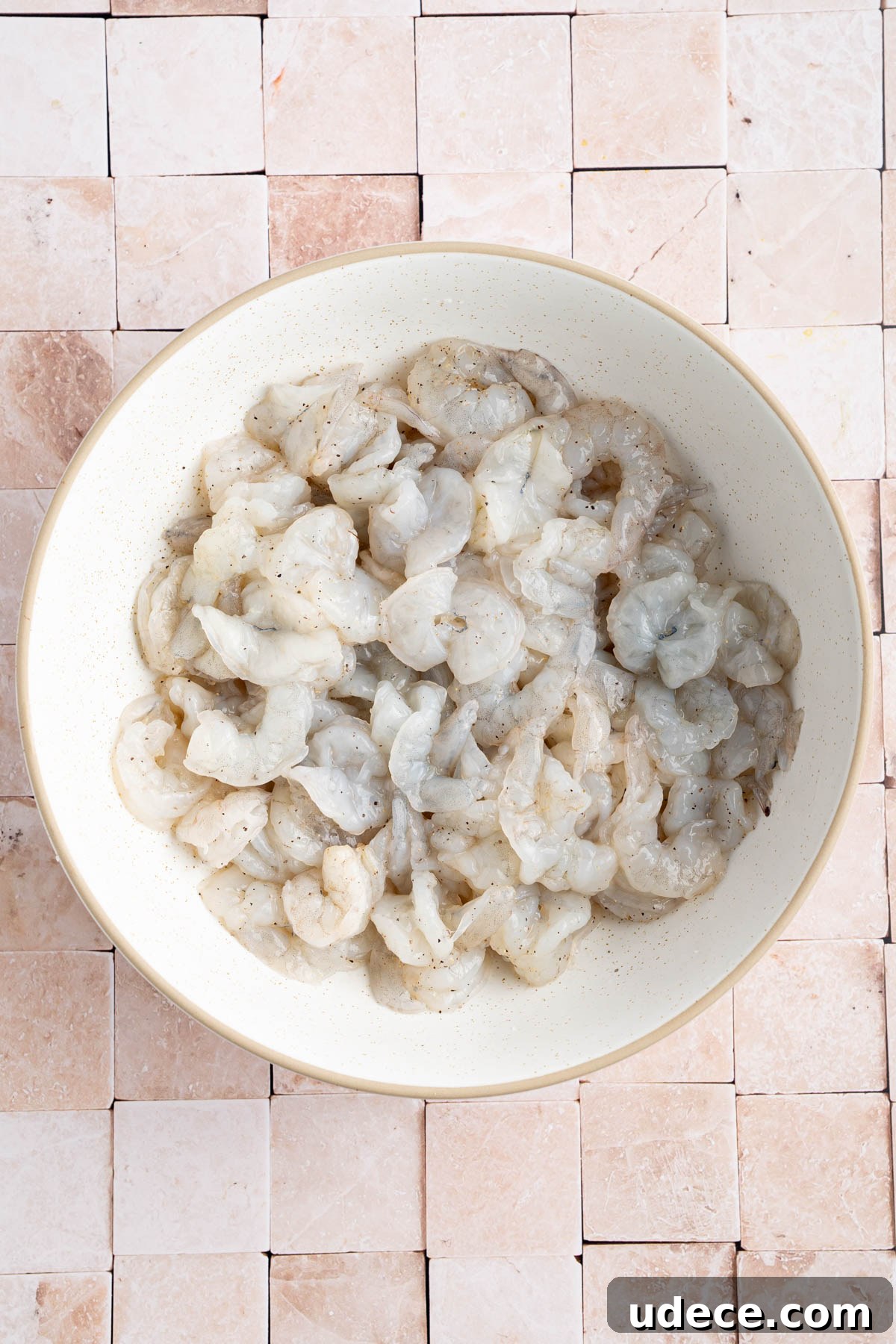 Aguachile de Camarón: Spicy Mexican Shrimp Recipe 3 The shrimp in a large bowl with salt and pepper.