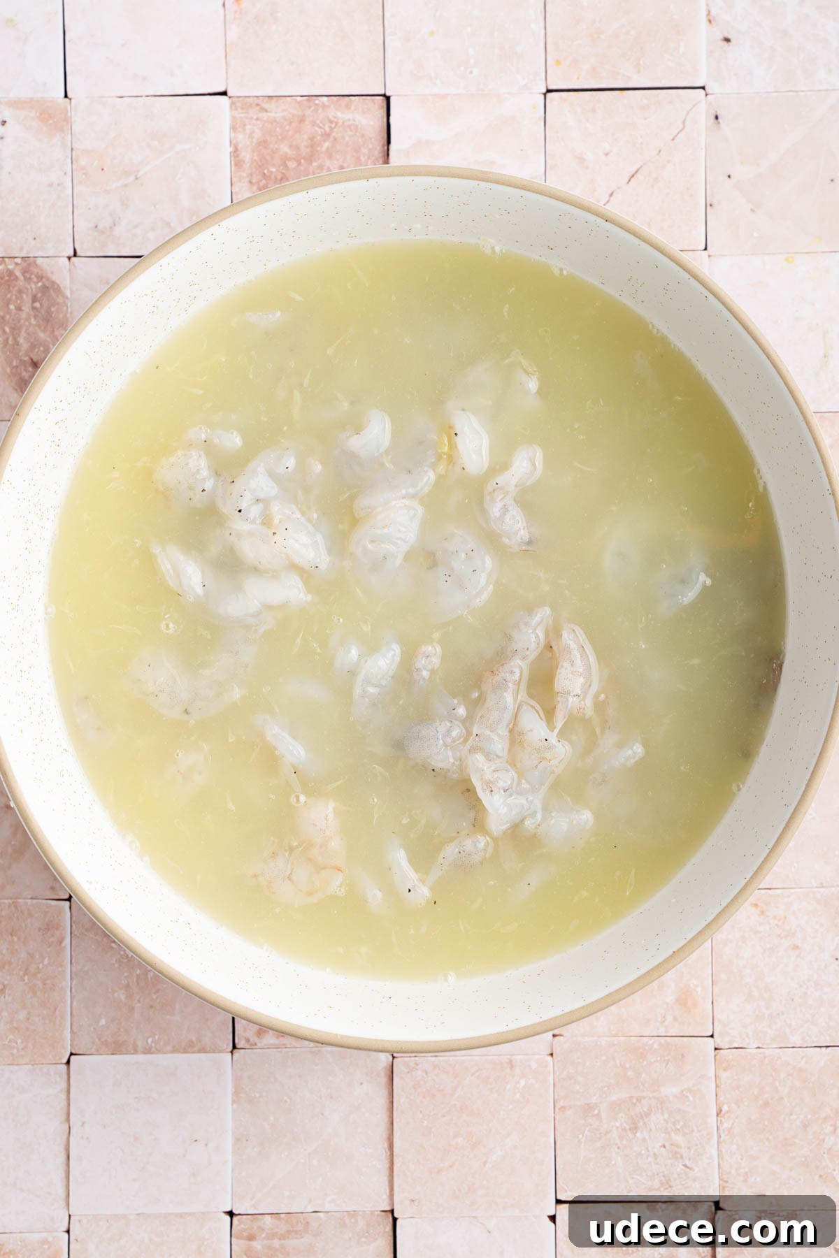 Aguachile de Camarón: Spicy Mexican Shrimp Recipe 4 The shrimp in a bowl covered in lime juice.