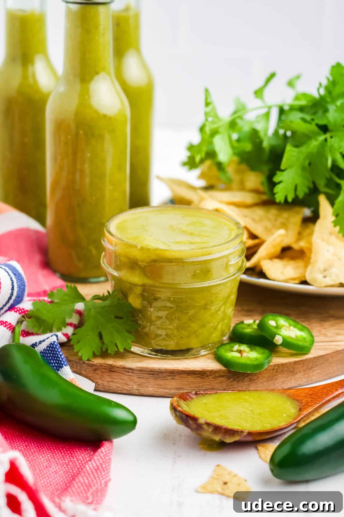 Homemade Jalapeño Hot Sauce Recipe for Bold Heat and Flavor 2 A small jar of jalapeno hot sauce with three bottles of it in the background.