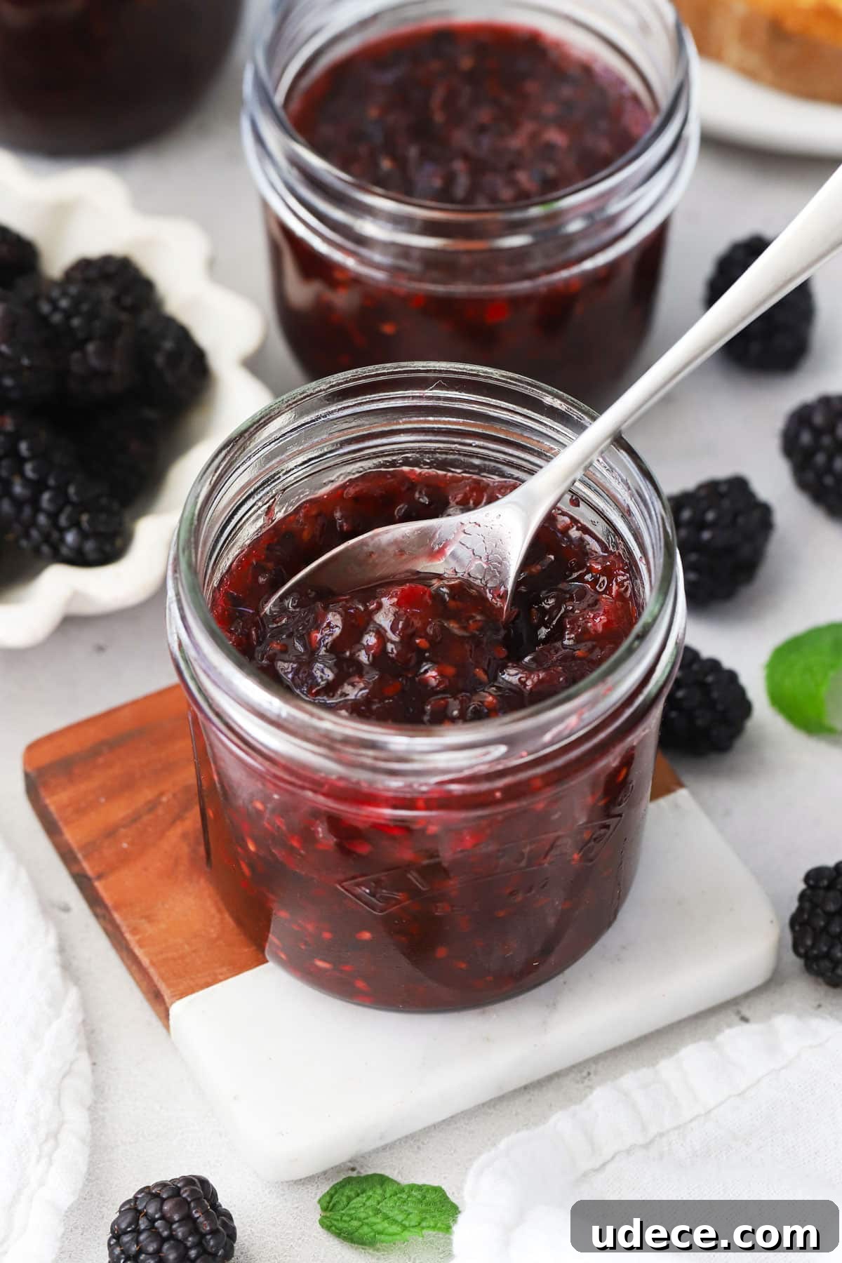 Blackberry Freezer Jam Recipe: Quick No-Cook Preserve 2 Spoon dipping into a jar of blackberry freezer jam