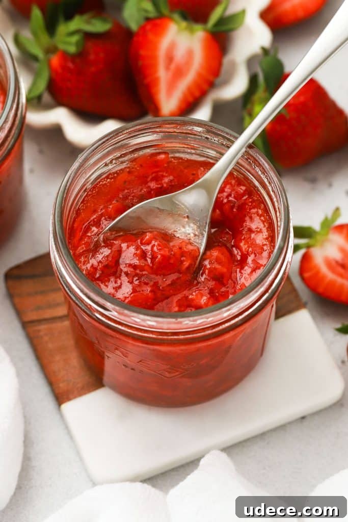Blackberry Freezer Jam Recipe: Quick No-Cook Preserve 11 Jars of homemade strawberry freezer jam surrounded by fresh strawberries