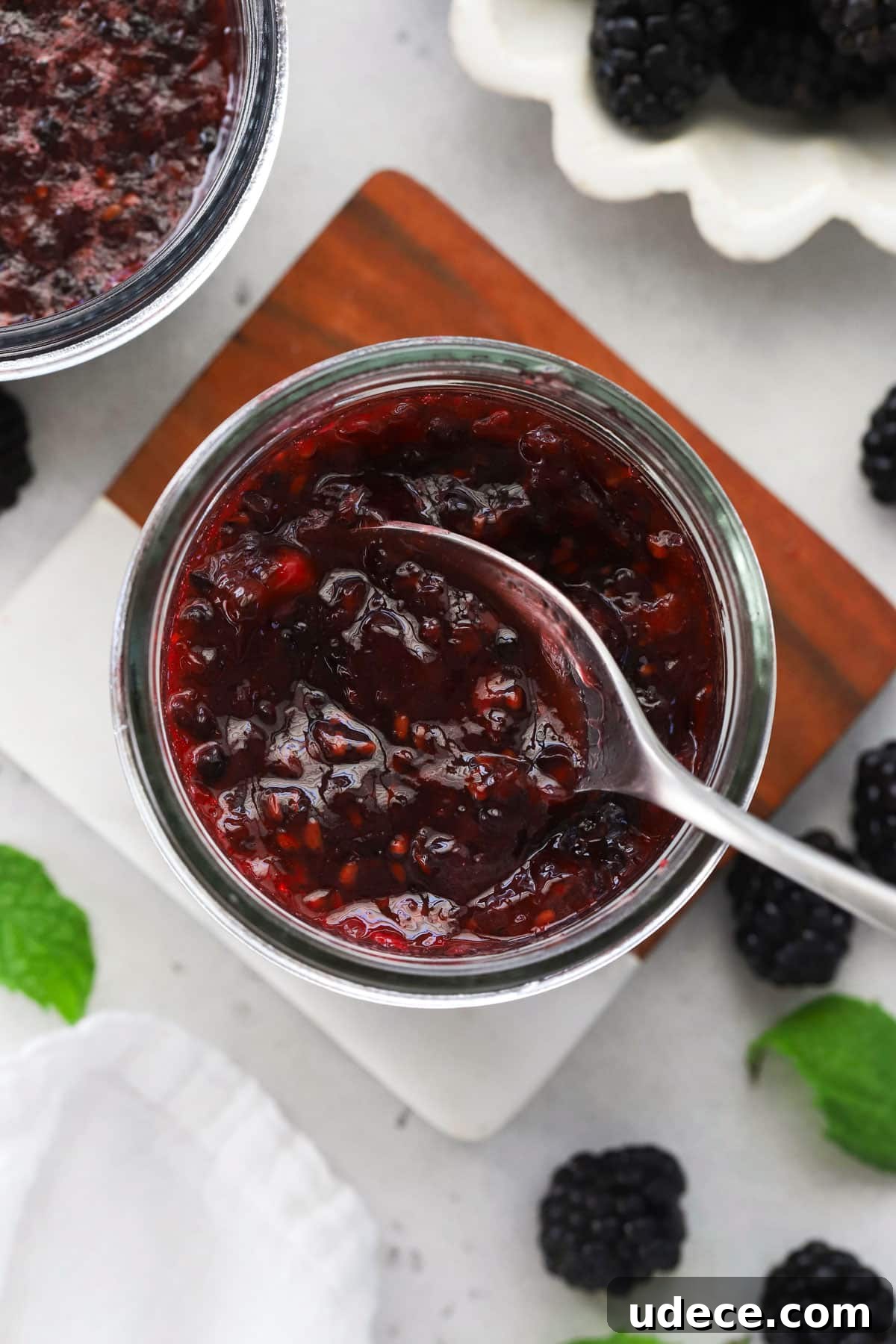 Blackberry Freezer Jam Recipe: Quick No-Cook Preserve 6 Spoon scooping blackberry freezer jam out of the jar