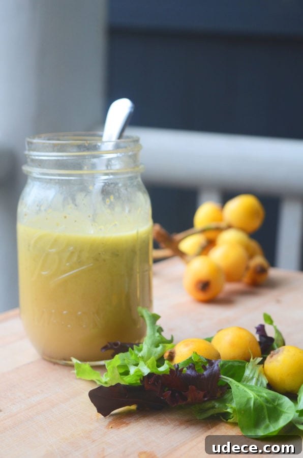 10+ Delicious Loquat Recipes to Try This Season 9 loquat vinaigrette in a jar with fresh lettuce and loquats