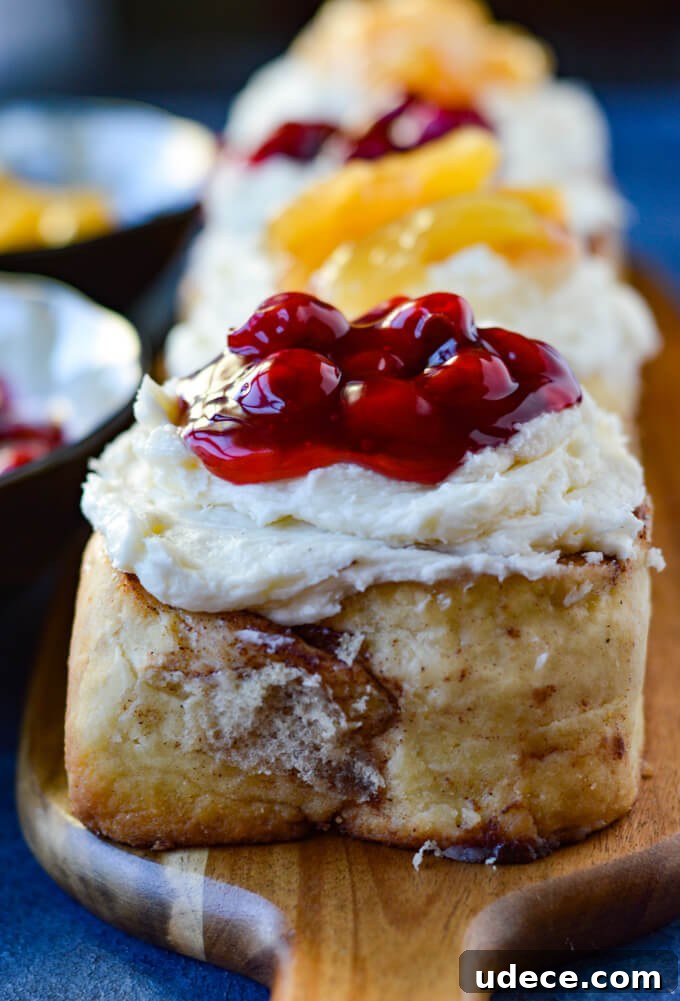 Perfect Homemade Cinnamon Rolls Recipe for Soft, Gooey Swirls 2 Front view of cinnamon rolls topped with cherry and apple pie filling.