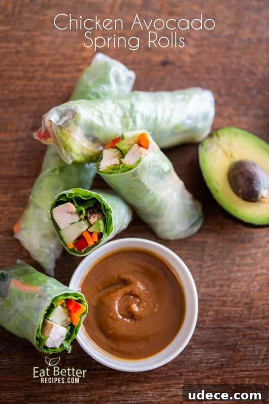Chicken Avocado Spring Rolls Recipe | @EatBetterRecipes Chicken Avocado Spring Rolls cut in half on a cutting board