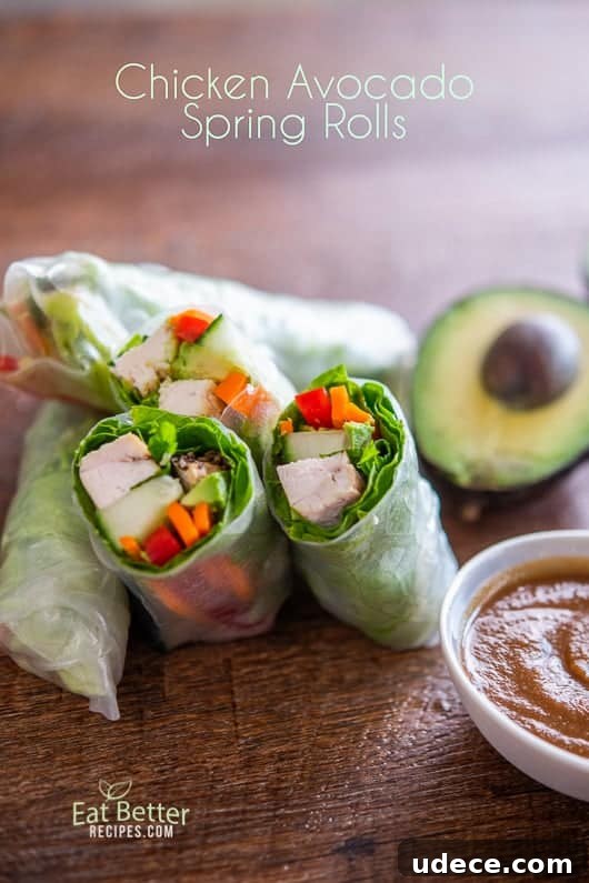 Chicken Avocado Spring Rolls Recipe | @EatBetterRecipes Chicken Avocado Spring Rolls cut in half on a board