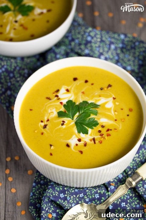 Curried Coconut Lentil Soup with Warm Spices Recipe 2 curried coconut lentil soup in a bowl with parsley and chilli flakes on top