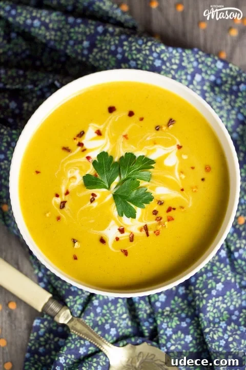 Curried Coconut Lentil Soup with Warm Spices Recipe 6 curried coconut lentil soup in a bowl with parsley and chilli flakes on top