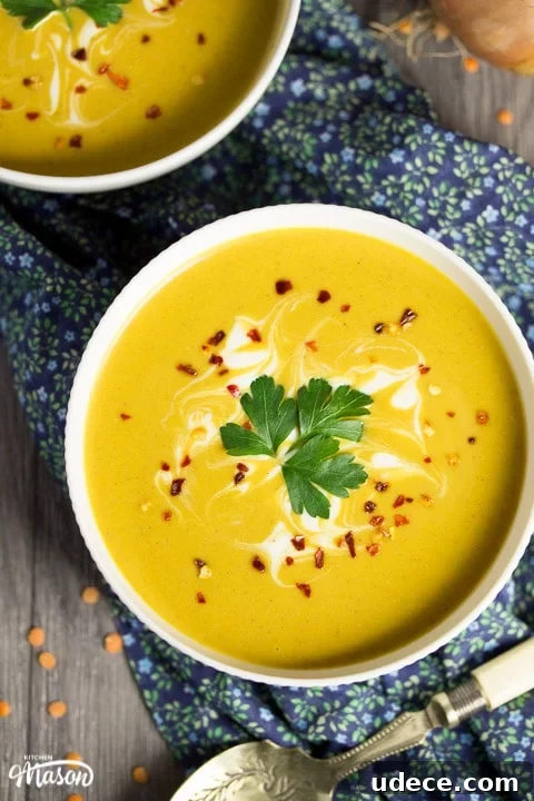 Curried Coconut Lentil Soup with Warm Spices Recipe 12 curried coconut lentil soup in a bowl with parsley and chilli flakes on top