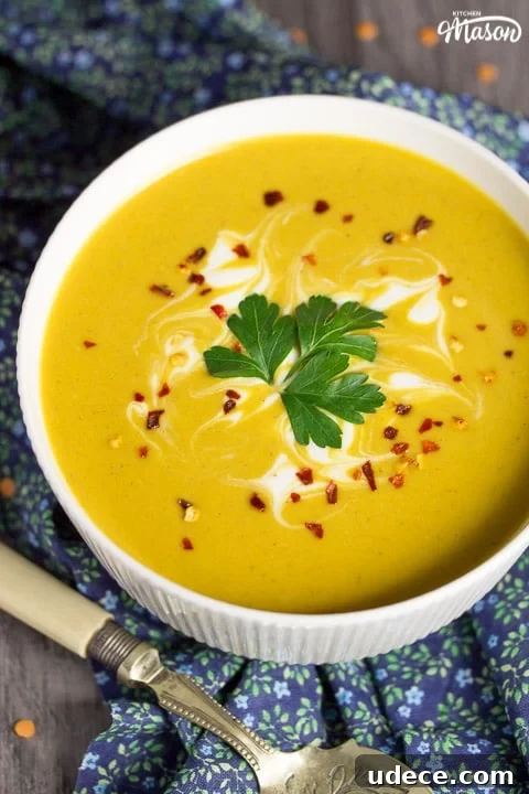 Curried Coconut Lentil Soup with Warm Spices Recipe 3 curried coconut lentil soup in a bowl with parsley and chilli flakes on top