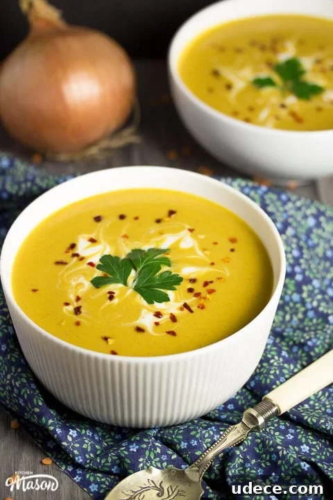 Curried Coconut Lentil Soup with Warm Spices Recipe 5 curried coconut lentil soup in a bowl with parsley and chilli flakes on top