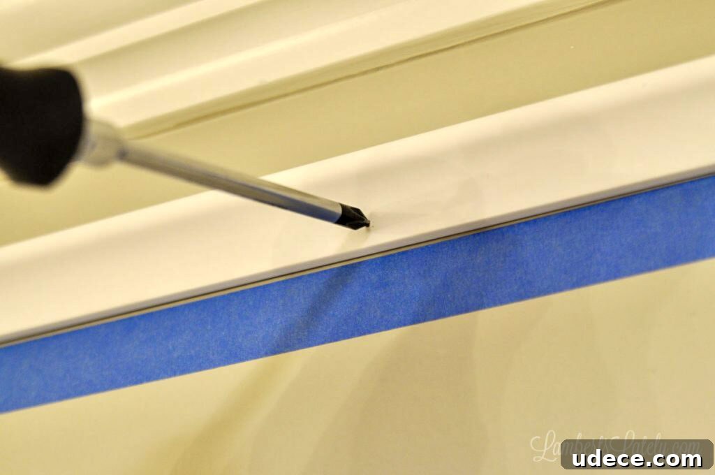 DIY Faux Crown Molding Guide: Simple Beginner-Friendly Hack 10 poking nails into molding with a screwdriver.