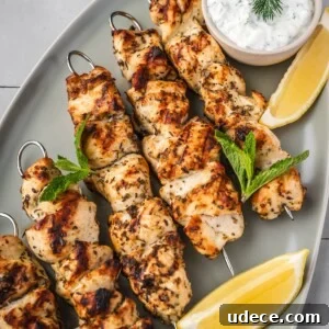 4 Mediterranean Meal Plans for Seasonal August Eating 7 Greek chicken souvlaki skewers on a platter garnished with dill, mint, sliced lemons and a side of yogurt sauce.