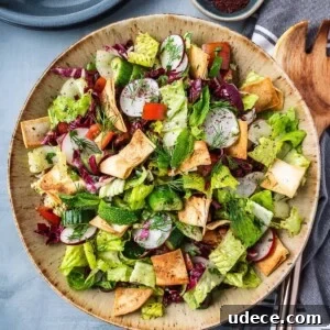4 Mediterranean Meal Plans for Seasonal August Eating 9 Chopped salad with lettuce, cucumbers and tomatoes in a bowl with crispy pita chips.