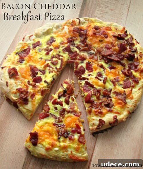 homemade bacon breakfast pizza Easy Homemade Bacon Cheddar Breakfast Pizza on cutting board.
