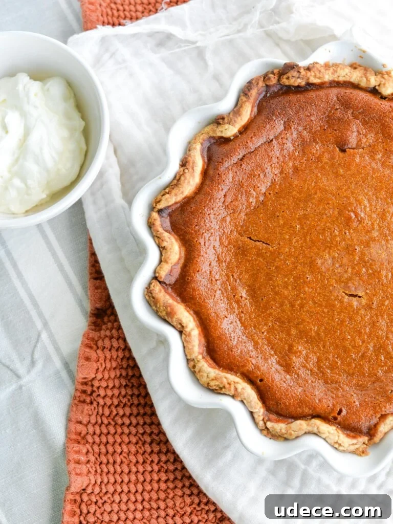 Sourdough Pumpkin Pie Recipe: Flaky Crust with Spiced Filling 13 Sourdough Pumpkin Pie with whipped cream next to it.