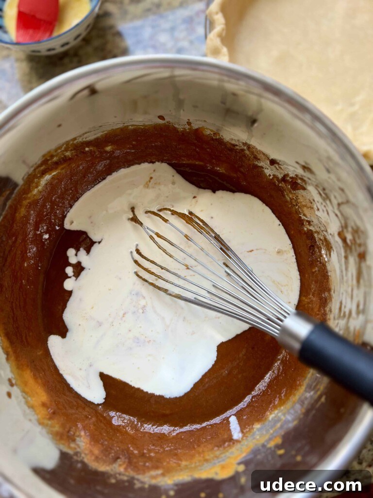 Sourdough Pumpkin Pie Recipe: Flaky Crust with Spiced Filling 8 Pouring filling into crust