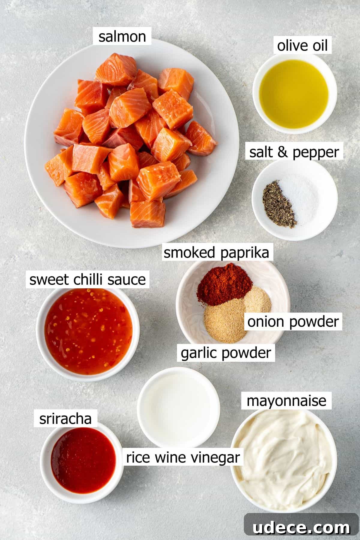 All ingredients needed to make bang bang salmon laid out in small bowls.